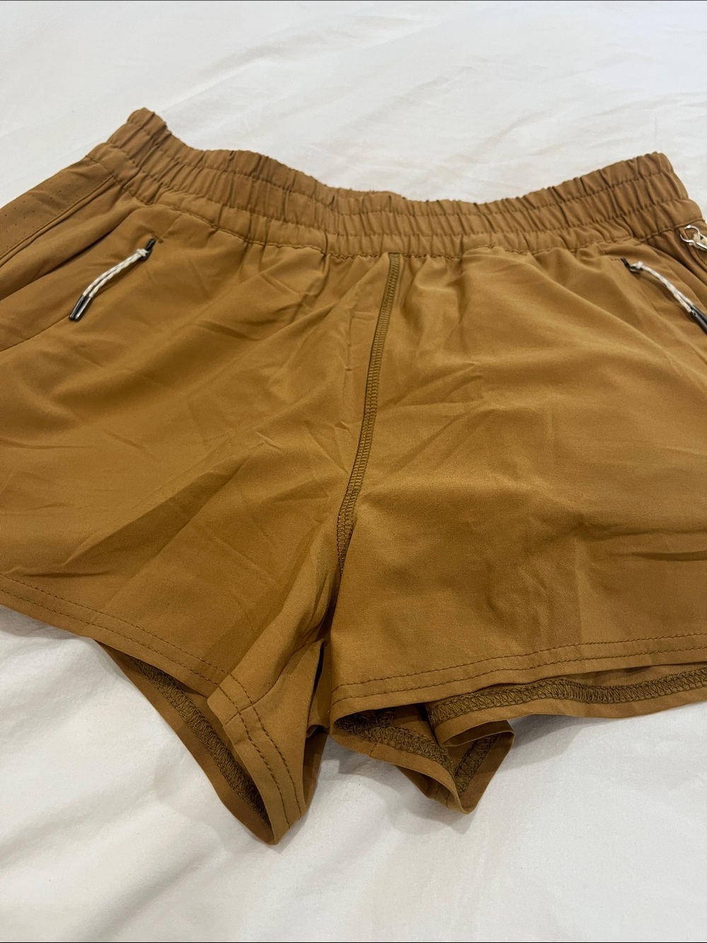 Vuori Women's Mustard Brown Athletic Shorts with Zip Pockets
